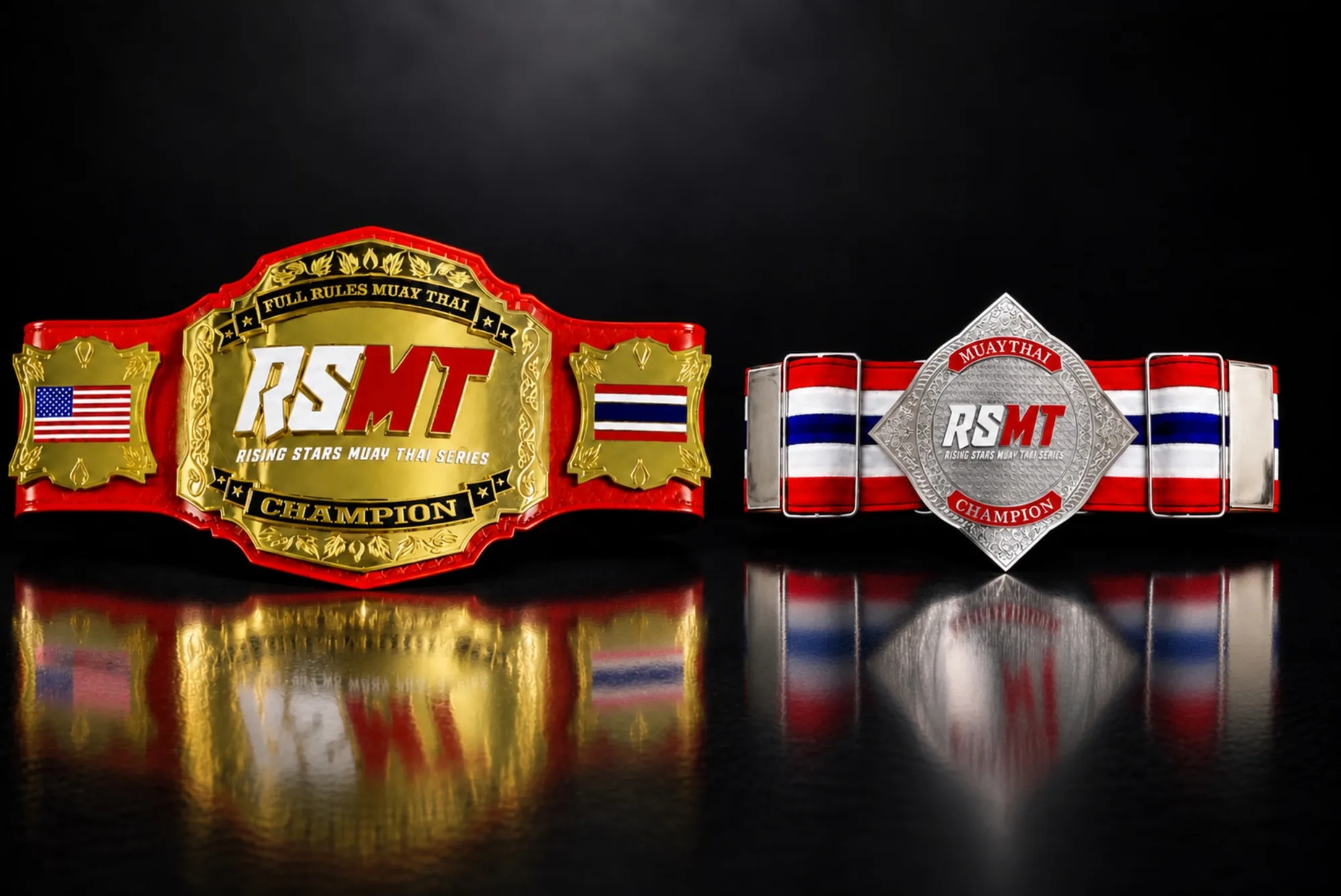 Two RSMT belts side by side on a black reflective surface. Left: the red RSMT championship belt with a gold center plate reading Full Rules Muay Thai, RSMT, Rising Stars Muay Thai Series, Champion, and US and Thai flag side plates. Right: the silver diamond-shaped RSMT Tournament Championship Belt on red, white and blue Thai-flag straps, reading Muay Thai, RSMT, Rising Stars Muay Thai Series, Champion.
